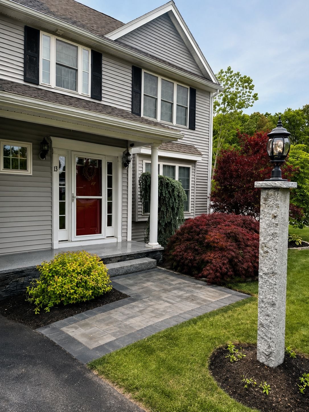 Granite bollard light post and paver walkway at a Truestone entry project