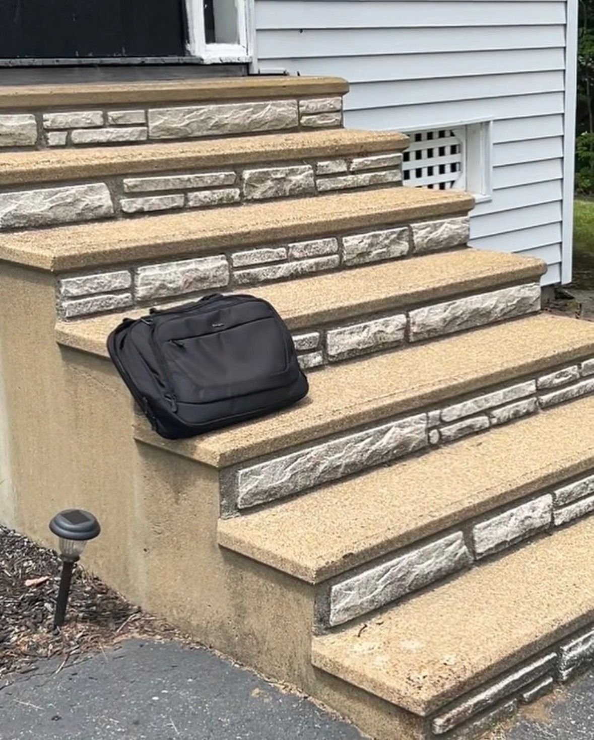 Aging concrete staircase with painted faux-stone risers prior to renovation